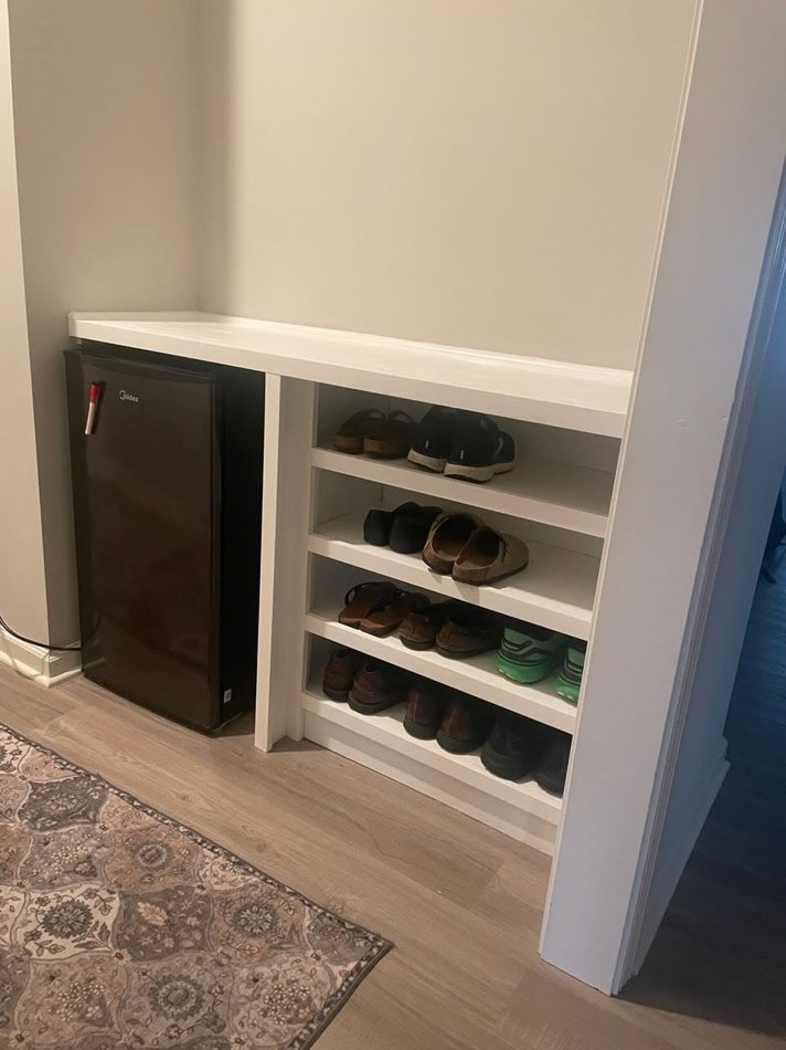 White built-in shoe shelves in an entryway